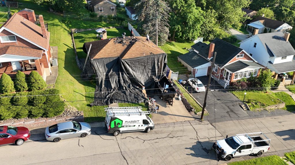 A home getting a brand new roof installed, with the property well protected
