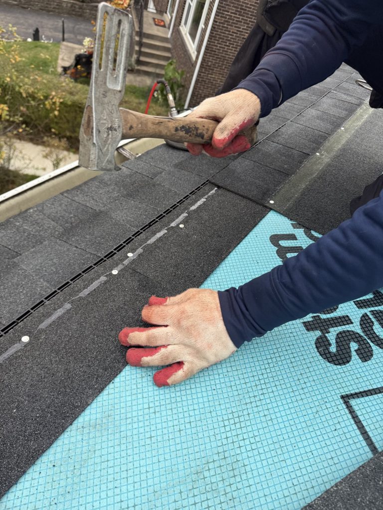 Asphalt roofing being installed